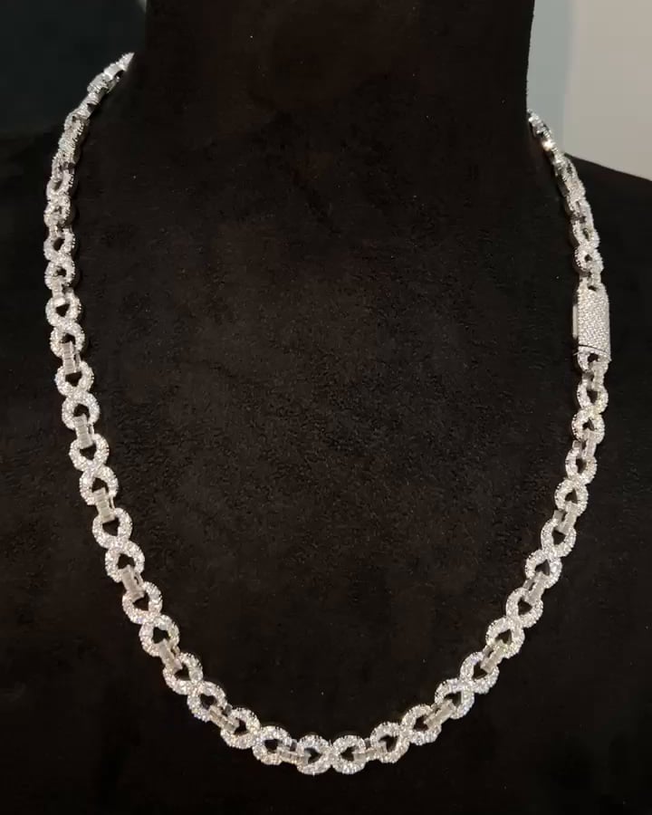 Slender stone-set open-link necklace with a rectangular clasp displayed on a dark bust.