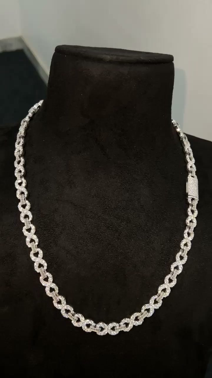 Slender stone-set open-link necklace with a rectangular clasp displayed on a dark bust.